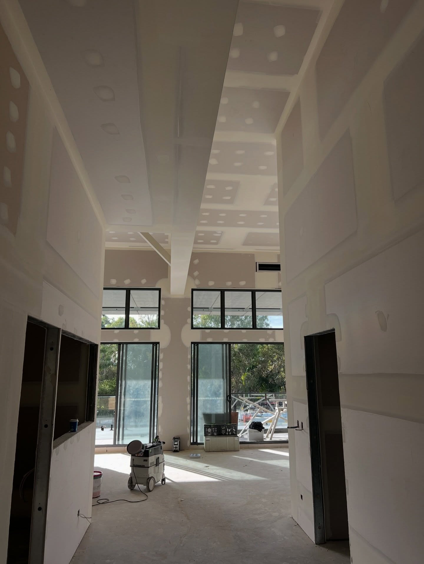 Plasterer applying smooth interior wall finish in a Hervey Bay home